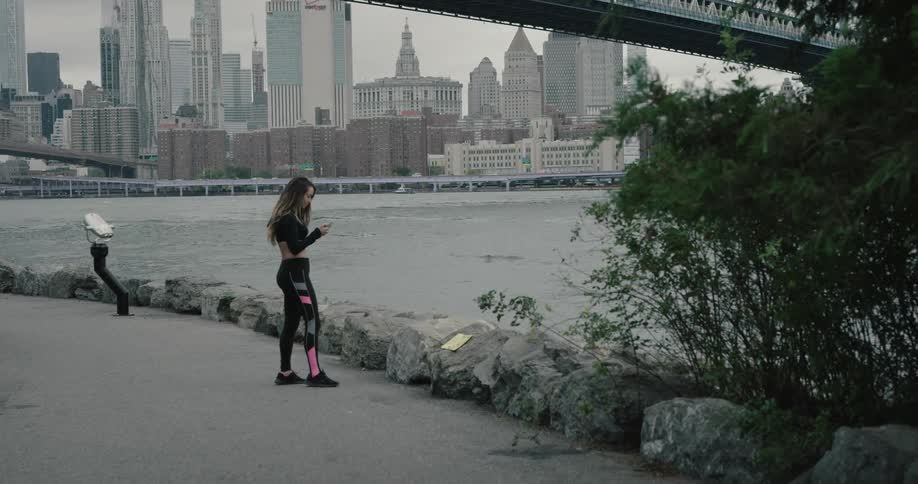 Young woman jogging and warming up at the public park alone