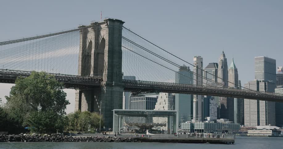 People walk near the water by the city