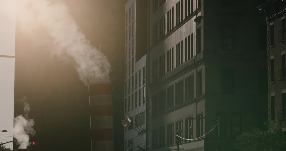 A chimney throwing out smokes in the morning on the downtown