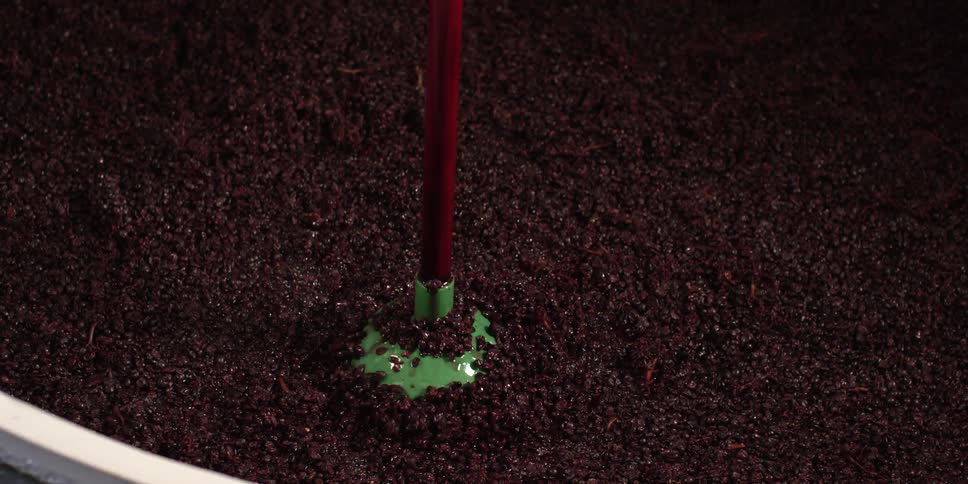 Plunger sinking into vat of dirt