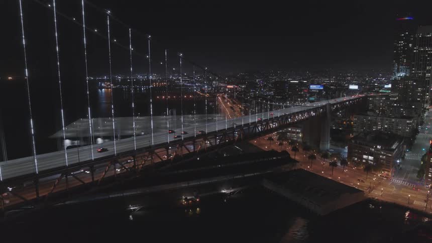 Landscape of cars driving across a busy bridge in a city