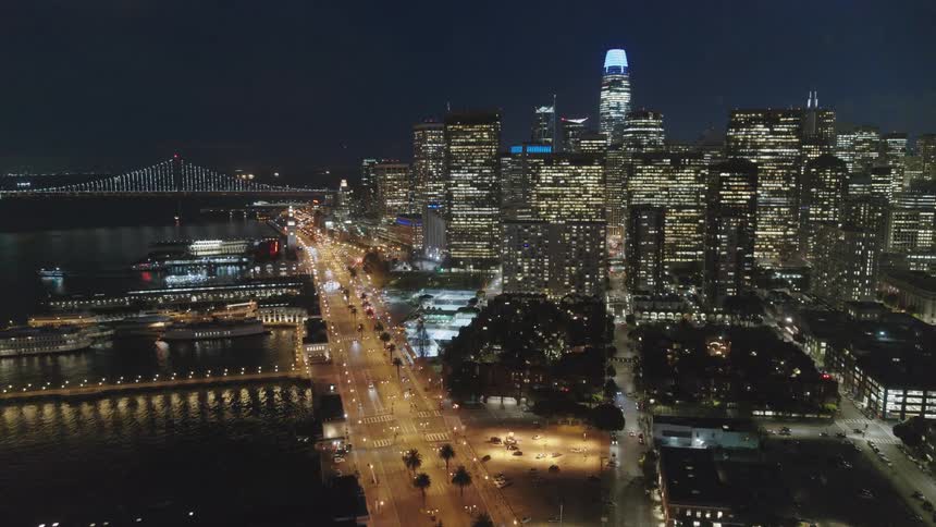 Skyline of the illuminated city with tall buildings at night