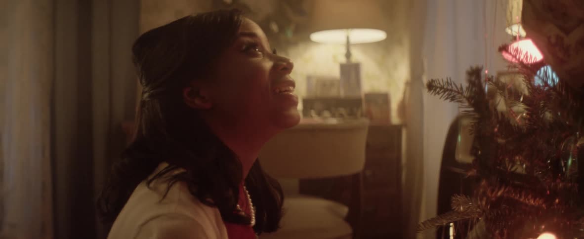 Black woman puts up your christmas decorations at home