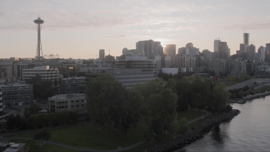 The sun shines over a large metro city