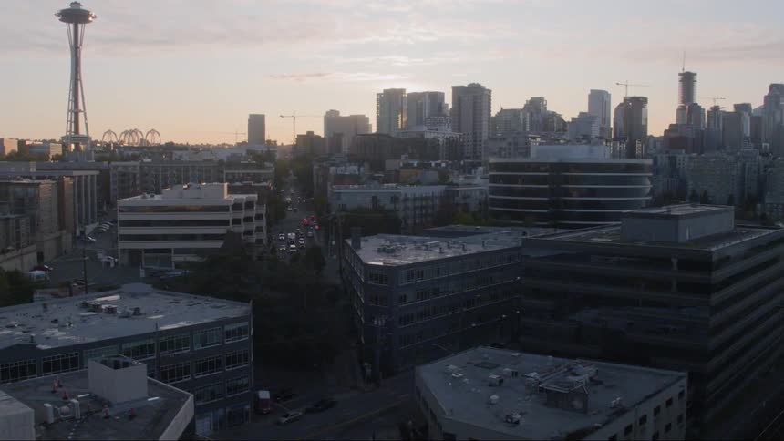 An aerial view of cars driving in a downtown area