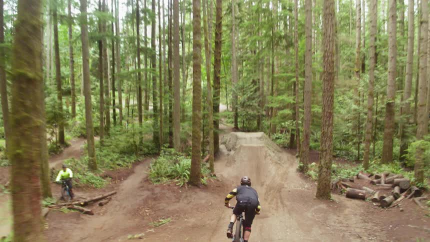 A man is doing tricks on a dirt bike