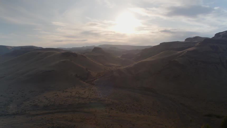 River cuts through low lying mountain range at dawn