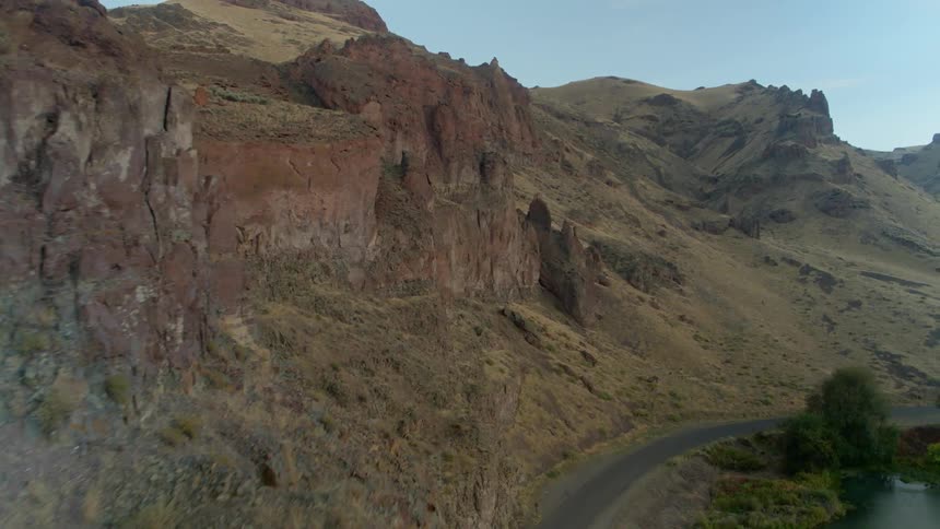 An aerial view of a mountain range and cliff