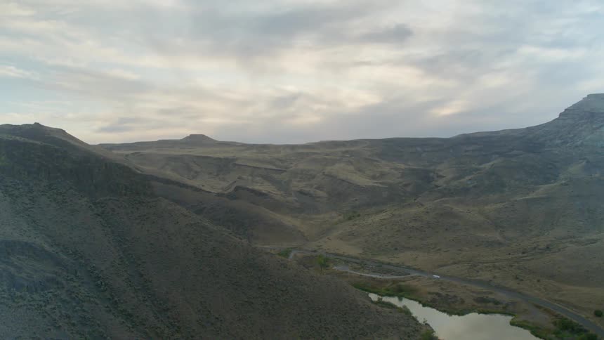A river winds through a shallow canyon