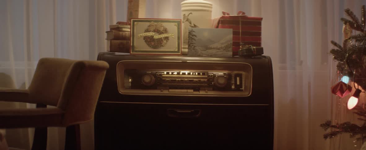 Old style radio functions as side table near christmas tree