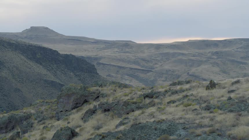 Grass starts to brown on top of mountain peaks