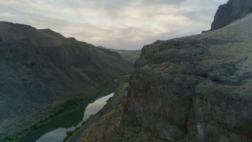 An aerial view of a river between rocky mountain