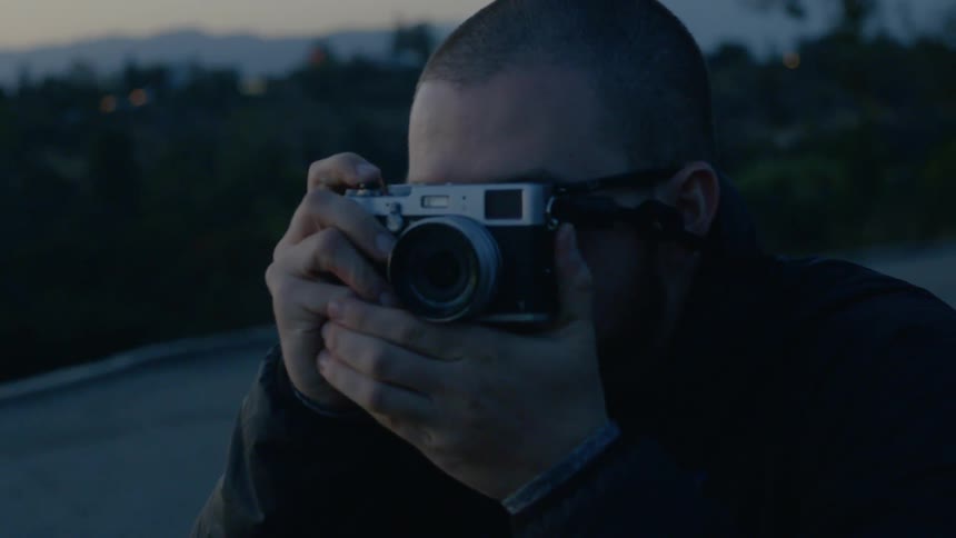 Man grabbing his camera to take a picture outdoors at night