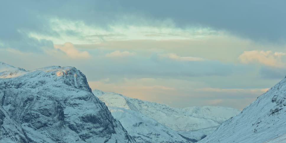 A time lapse of an iced mountain peak