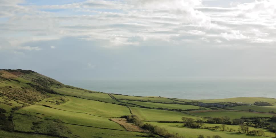 A vast and hilly countryside on a cloudy day