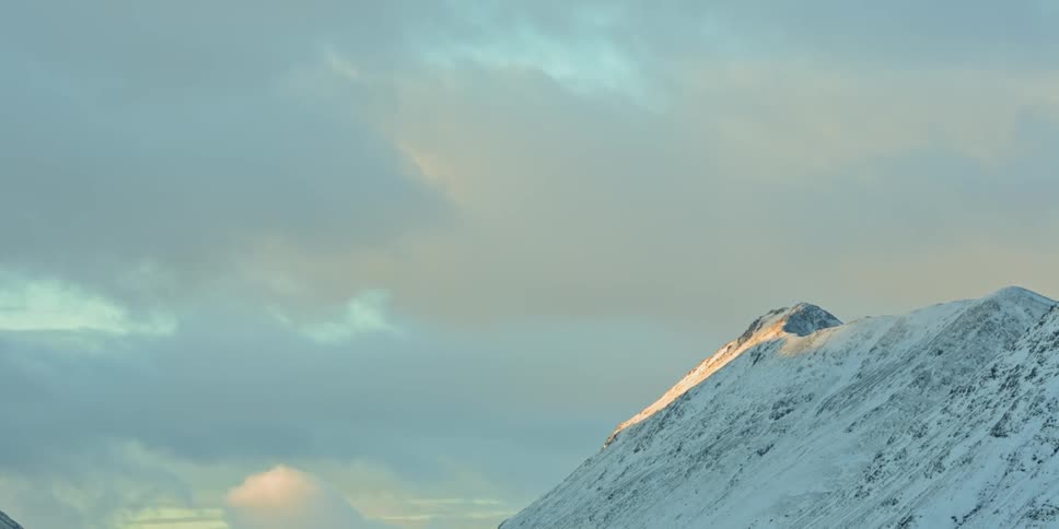 The sun shining on the snow covered mountain