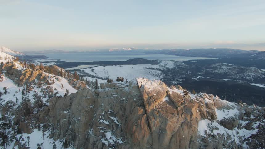 The mountain range has some trees at the top
