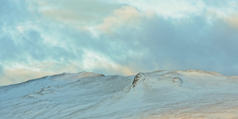 A scenery of a snowy mountain summit