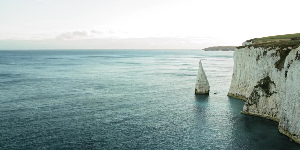 The cliff leads to a vast ocean
