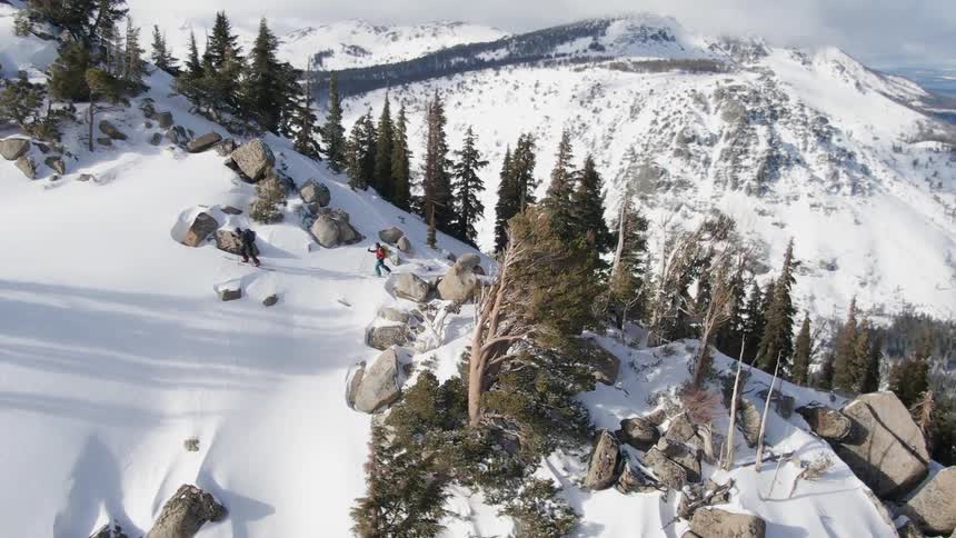 People are hiking up a snowy mountain