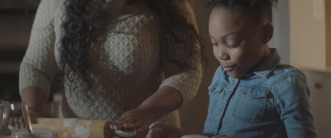 A woman and child work together in the kitchen
