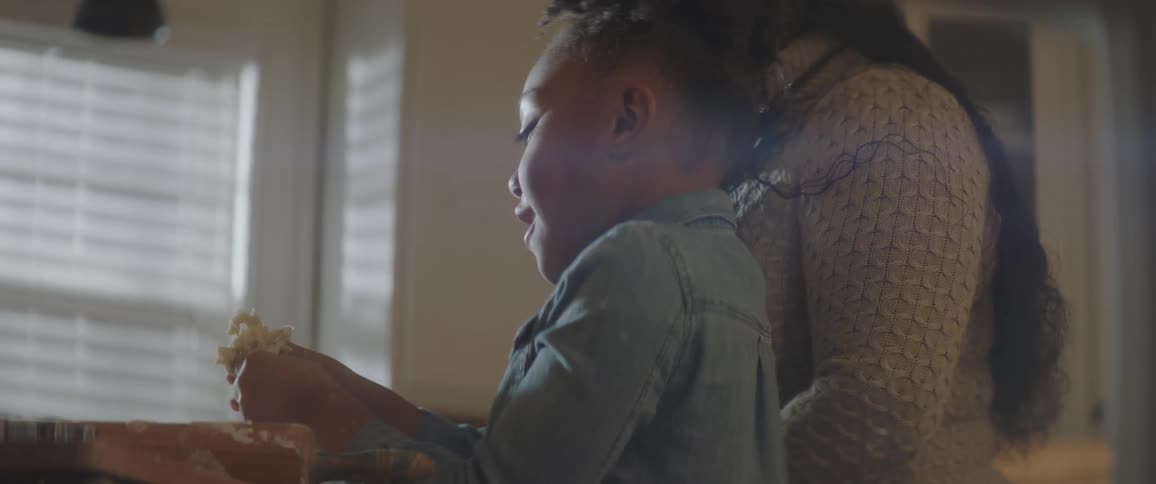 Mother helps her son play with dough