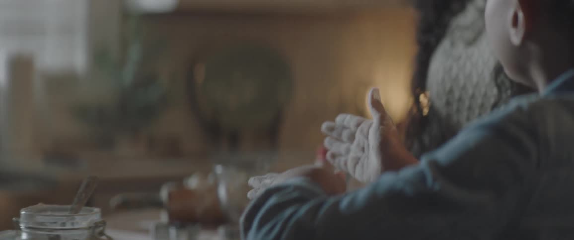 A mother and daughter bake cookies together in the kitchen