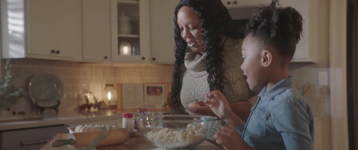 Mother and daughter prepare some baking in the kitchen