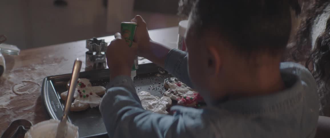 A girl stuffing a ginger bread cake
