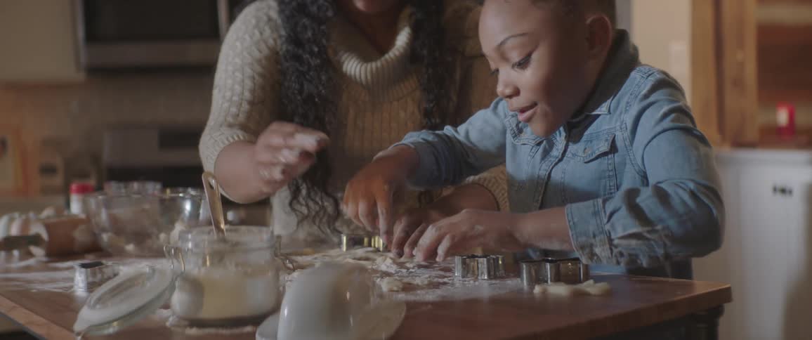 Mother and daughter cook at the kitchen