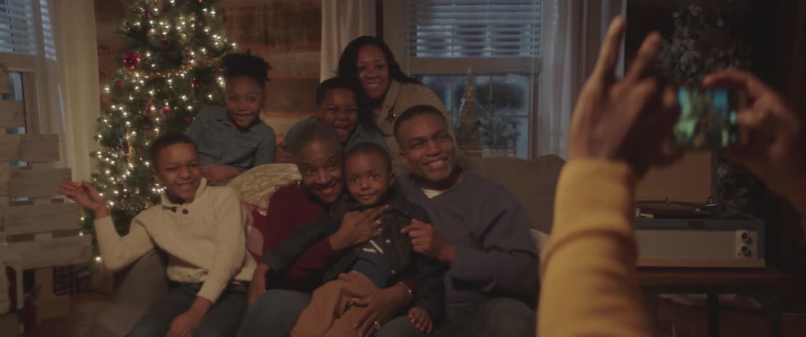 Family taking picture with smartphone camera on the christmas day