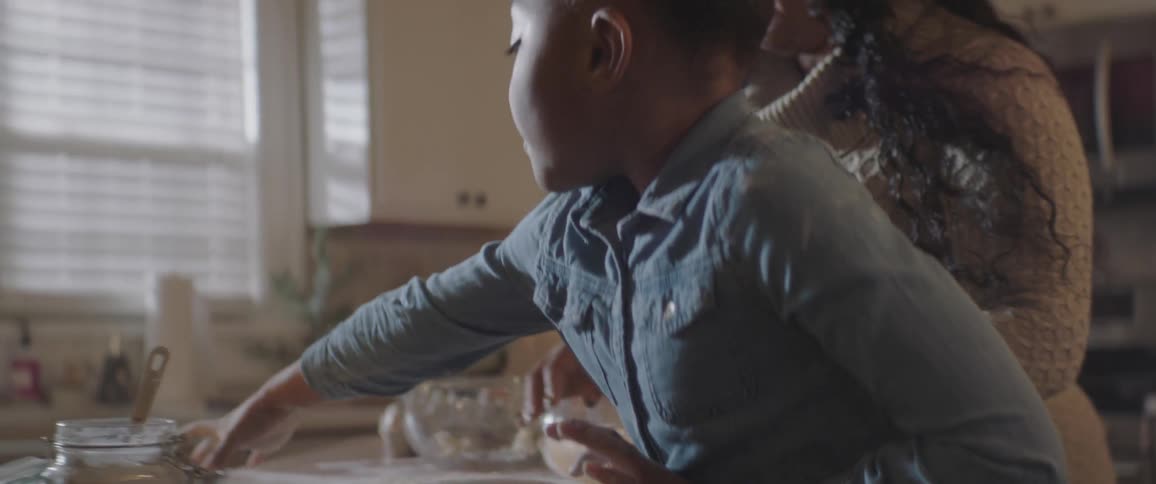 Mother and child are making dough together