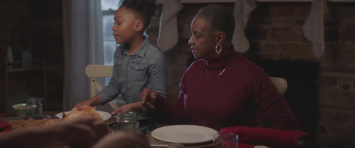 Family sits at the table for dinner at night