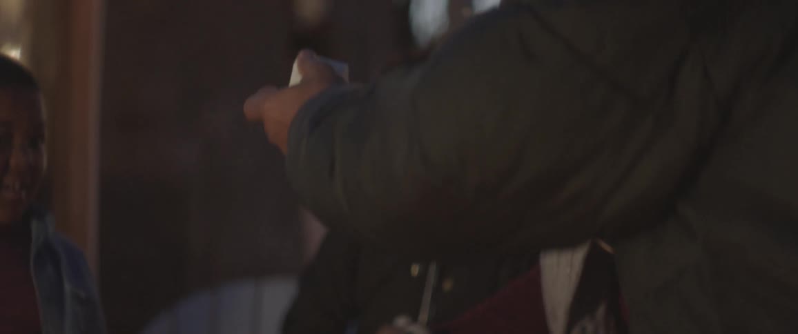 A man prepares to stick a marshmallow on a stick for roasting