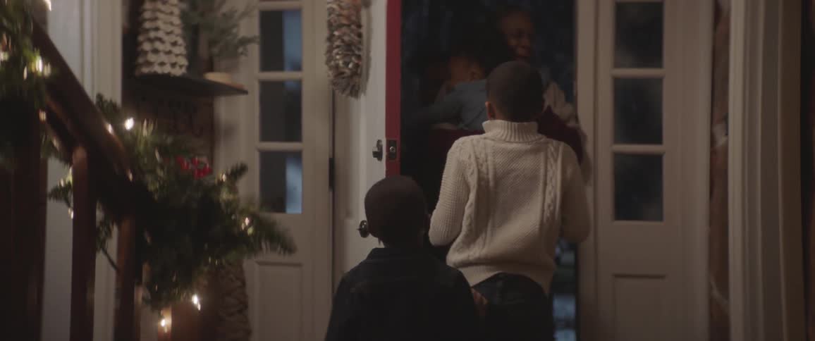 Children run down the stairs to open the door