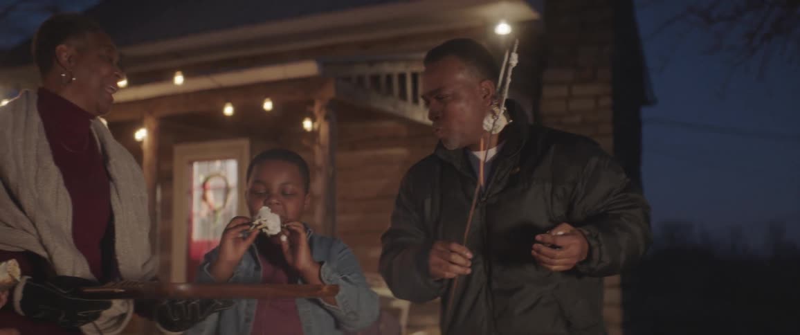 People laugh and eat marshmallows they roasted