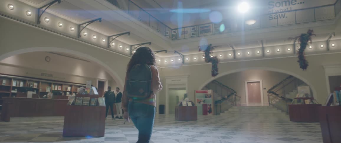People walk through the open lobby of a public library
