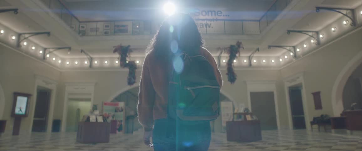 A woman carries a bag and then lifts it to her shoulder