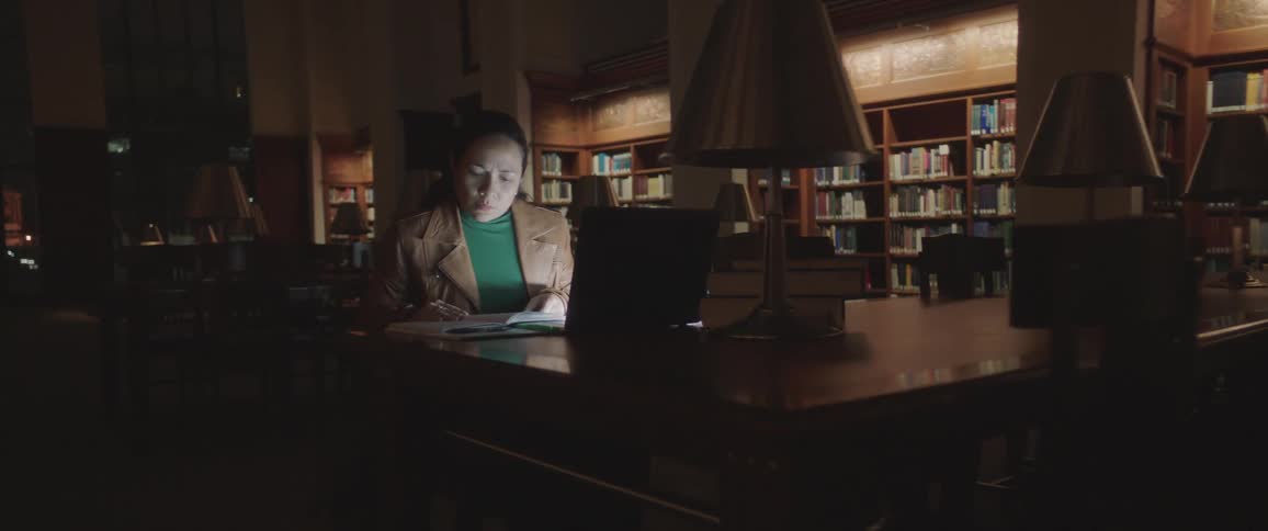 A woman is using her laptop in the libraries