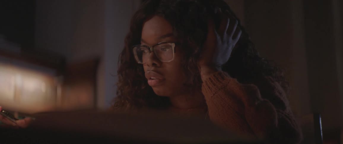 A young woman writes and reads in a book