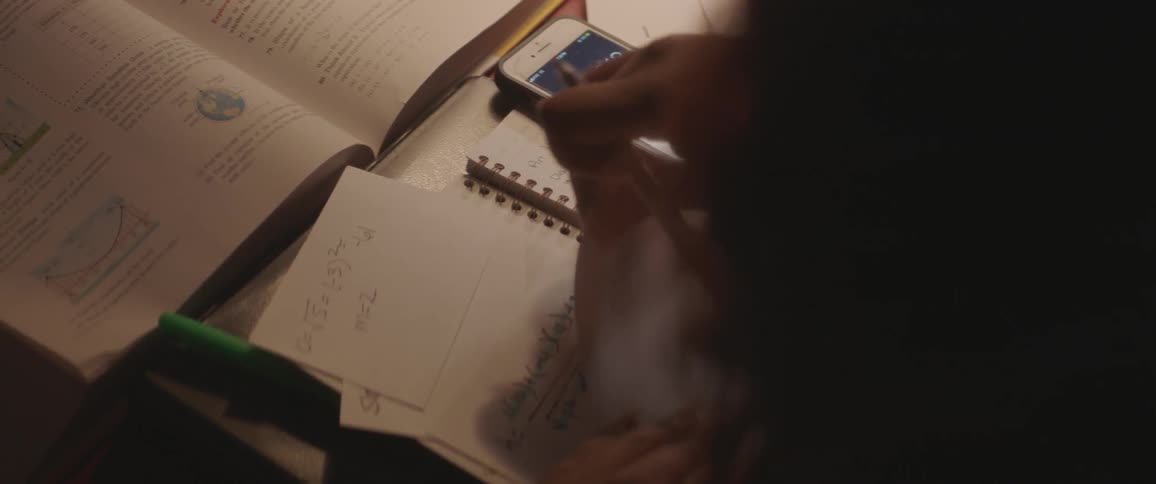A person lays note cards in front of them to write on