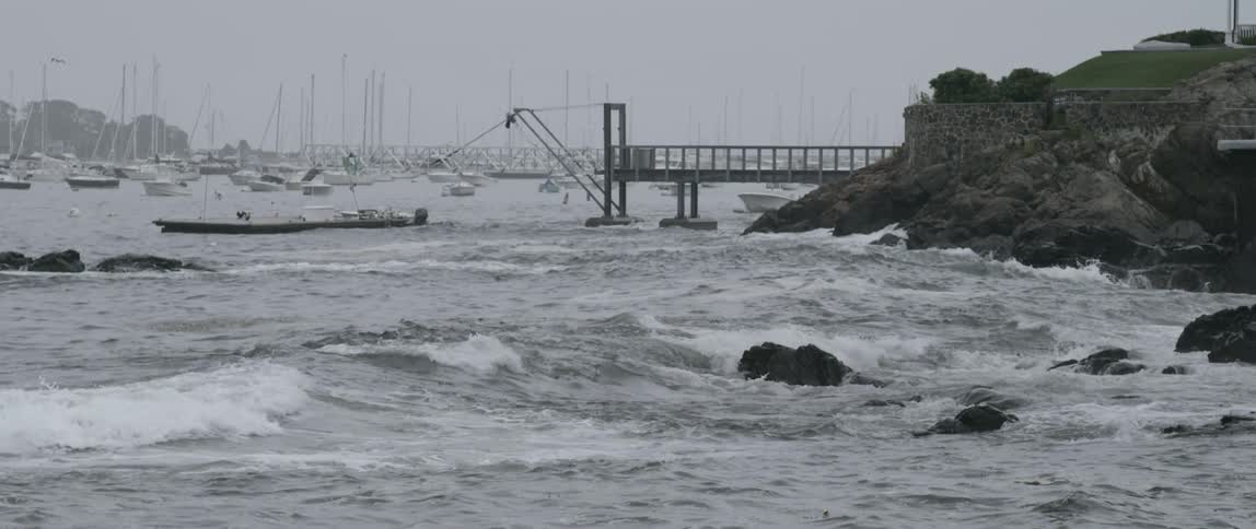 Landscape of crashing waves at a harbor