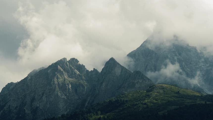 Fog flows over mountains and hills during the day
