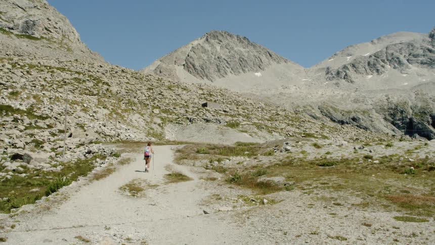 A person hiking in the desert with mountains in the background
