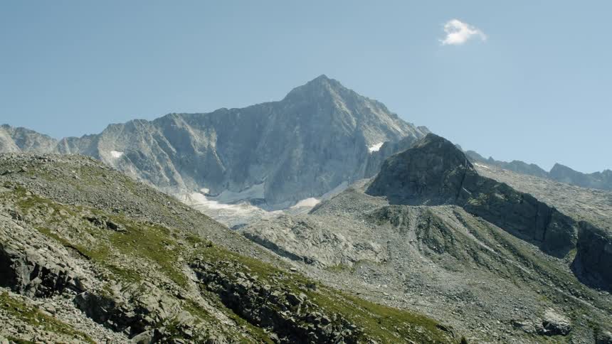 Mountain range under slightly clouded sky