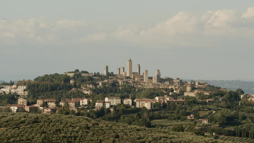 Past the tree lined hills is a large city