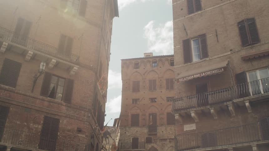 Sunlight shines over brick buildings in a town