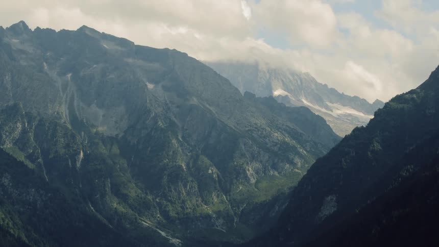 Clouds hang over a mountain range