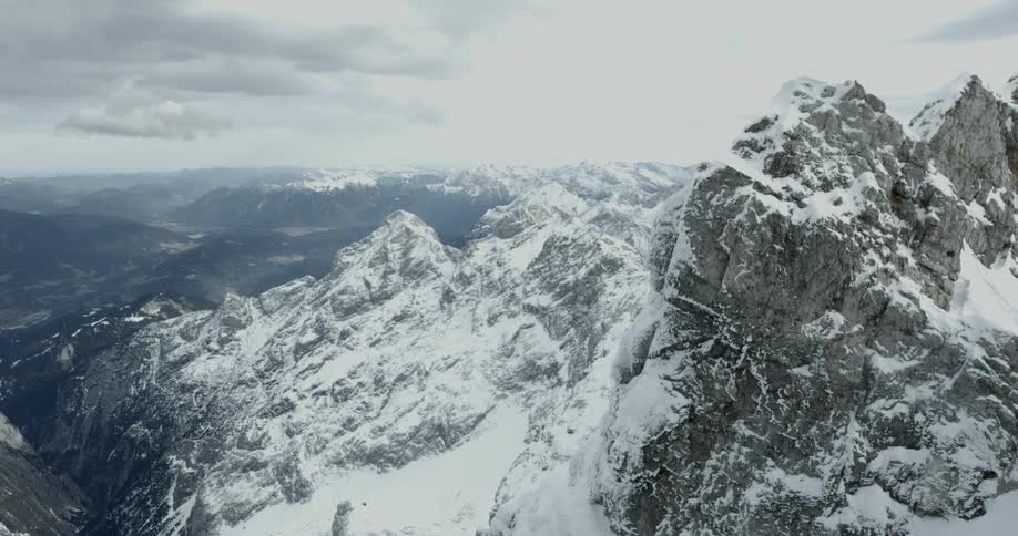 The mountain range below is covered with snow