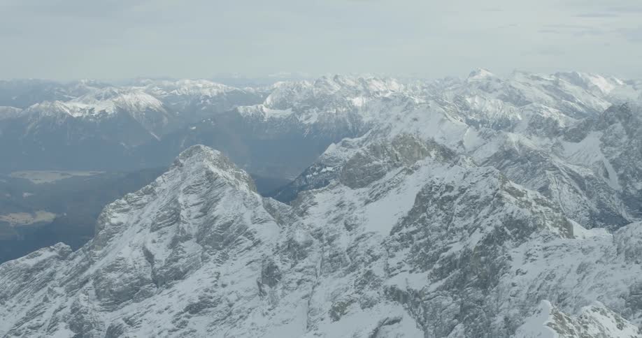 A light dusting of snow covers a vast mountain range